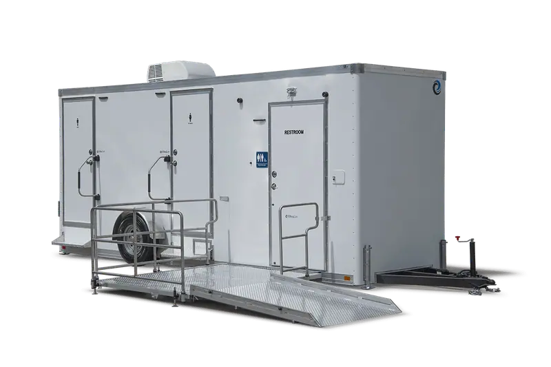 The ADA+4 Restroom Trailer has three separate entrances with clear restroom signs, plus an ADA-compliant restroom featuring a metal ramp for easy accessibility.