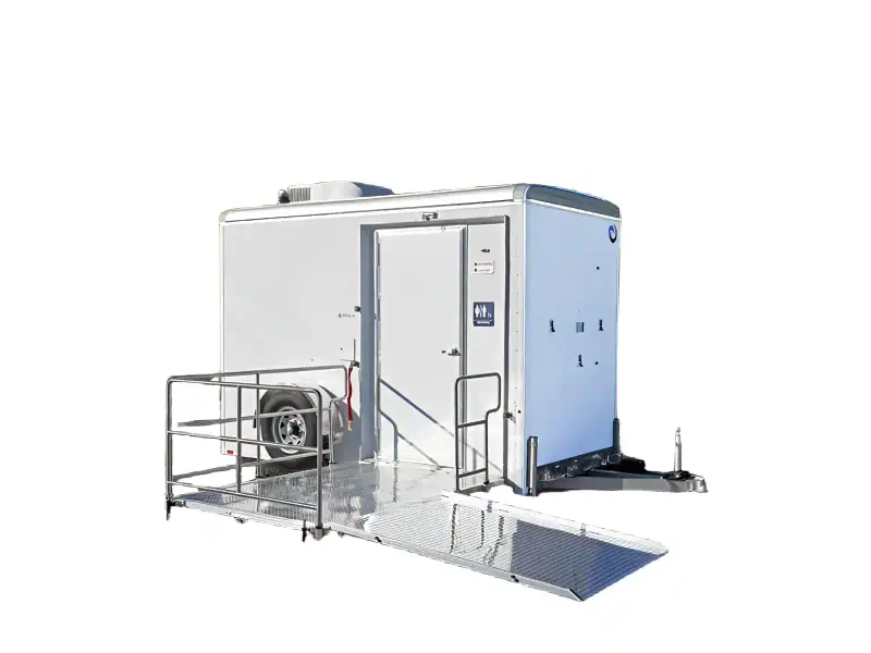 The ADA Single Restroom and Restroom Shower Trailer features a white exterior, metal accessibility ramp, entry steps, and a unisex restroom sign on the door, shown isolated on a white background.