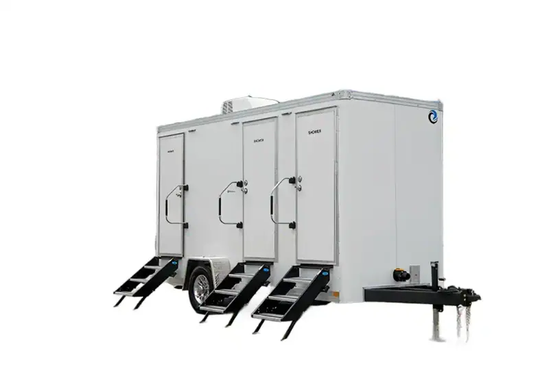The 3 private room shower restroom and laundry trailer features three separate doors with stairs and labeled entries, is set on wheels for easy mobility, and provides convenient, accessible ADA restroom and laundry options.