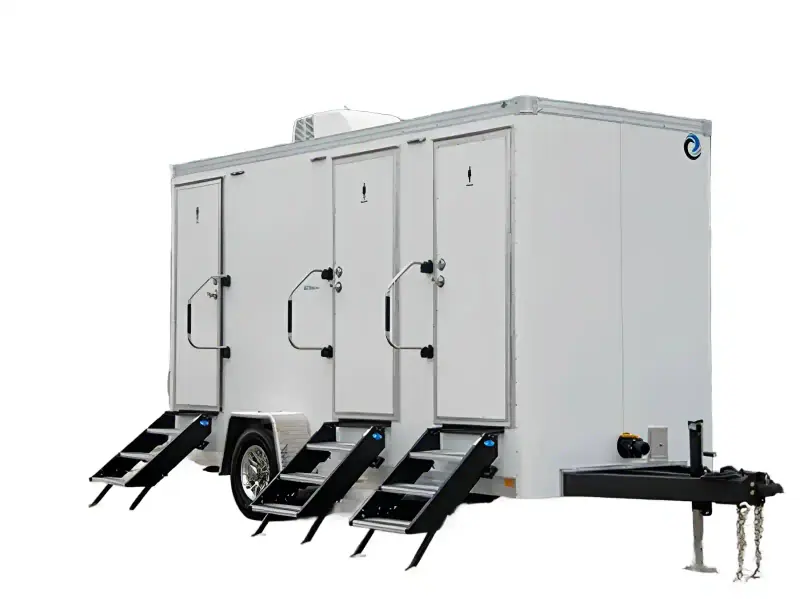 The 3 private room restroom trailer (16′ x 6′) features three separate doors, black steps, and a trailer hitch for towing. One section offers an ADA-accessible restroom for added convenience.