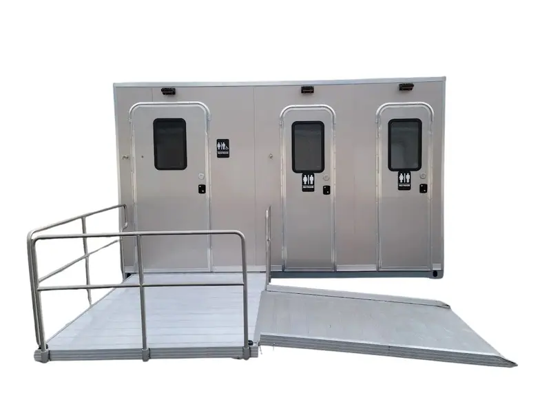 The CI 13 - 4 Stall ADA Restroom Skid (13 ft) is shown against a white background, featuring three doors and an accessible ramp for enhanced accessibility with an ADA-compliant restroom.